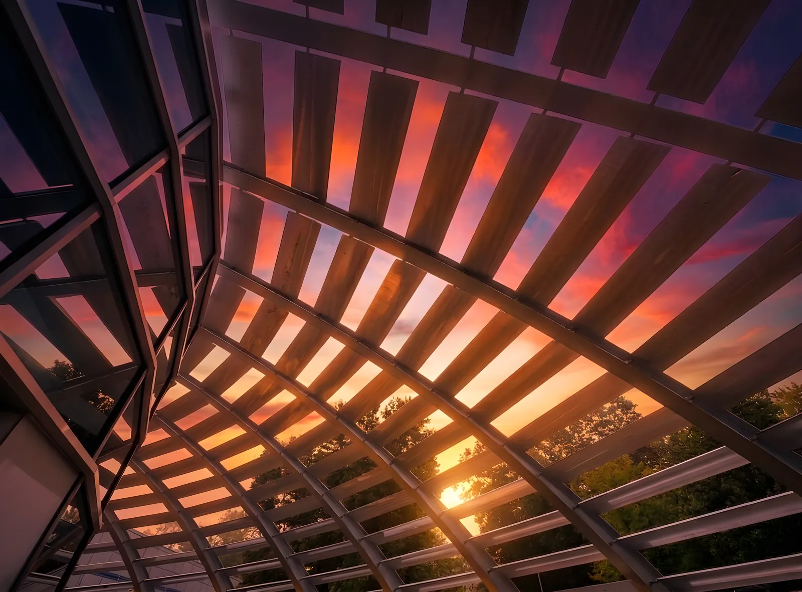 Sunset seen through the steel lattice of the World Park campus dome in Alpharetta, Georgia