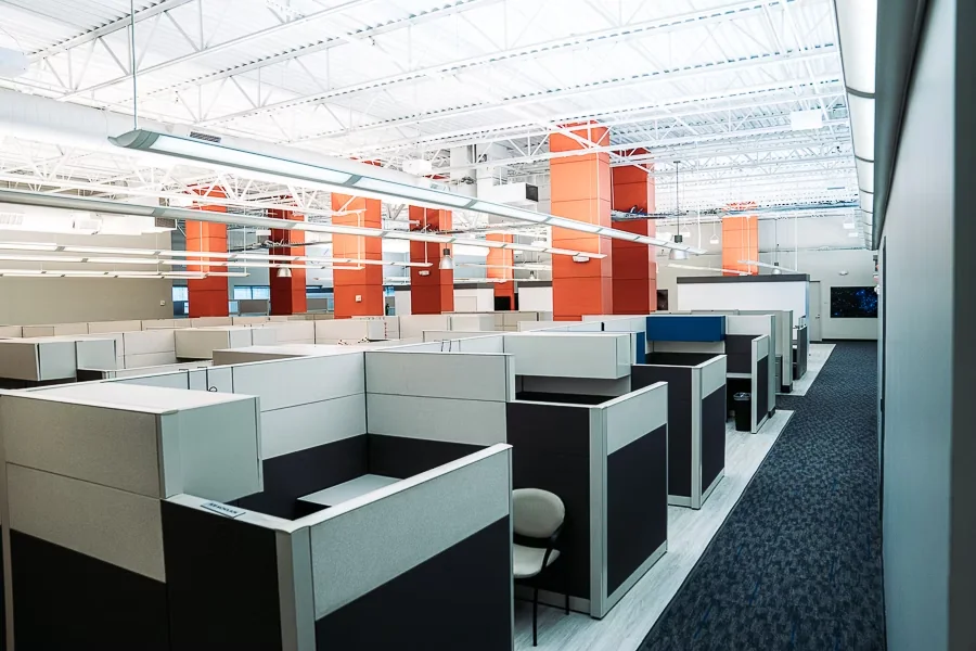 Open campus workspace with private team suites under high industrial ceilings at World Park Alpharetta