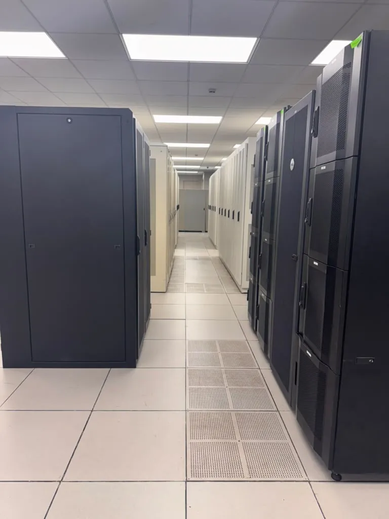 Row of black server cabinets on a raised tile floor in the MarQi Cloud data hall at World Park Alpharetta