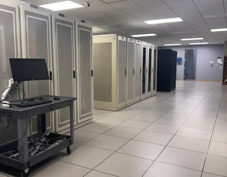 Cabinet aisle inside the MarQi Cloud data center at World Park in Alpharetta, Georgia, with a mobile console cart