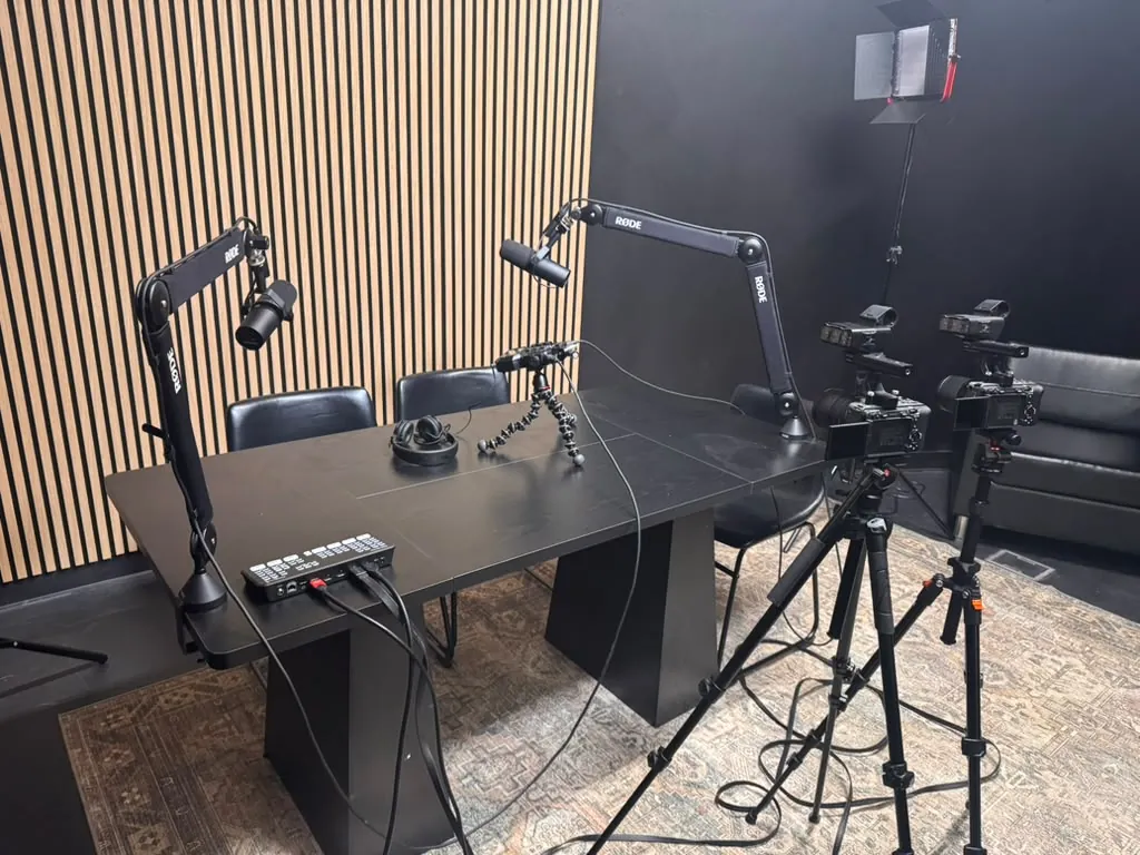 Broadcast microphones, a cinema camera and tripods set up in the World Park podcast studio in Alpharetta, Georgia