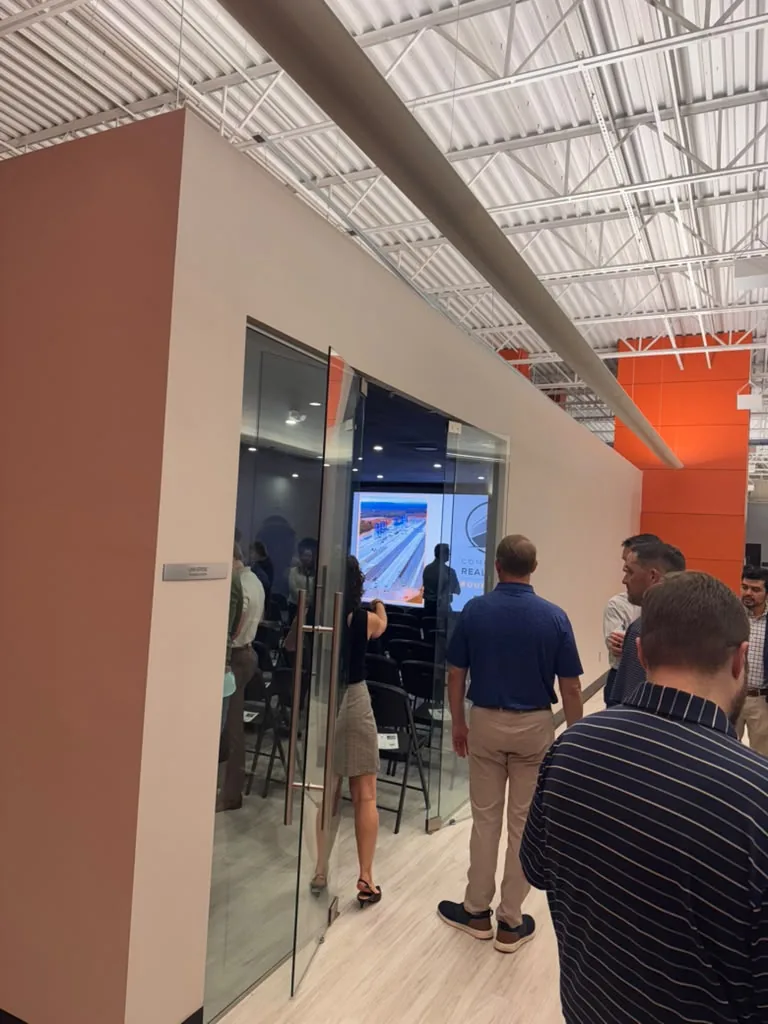 Guests entering the Universe Training Room through its glass doors during a chamber event at World Park