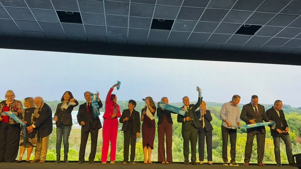 Ribbon cutting on stage at the WealthWave world headquarters grand opening at World Park