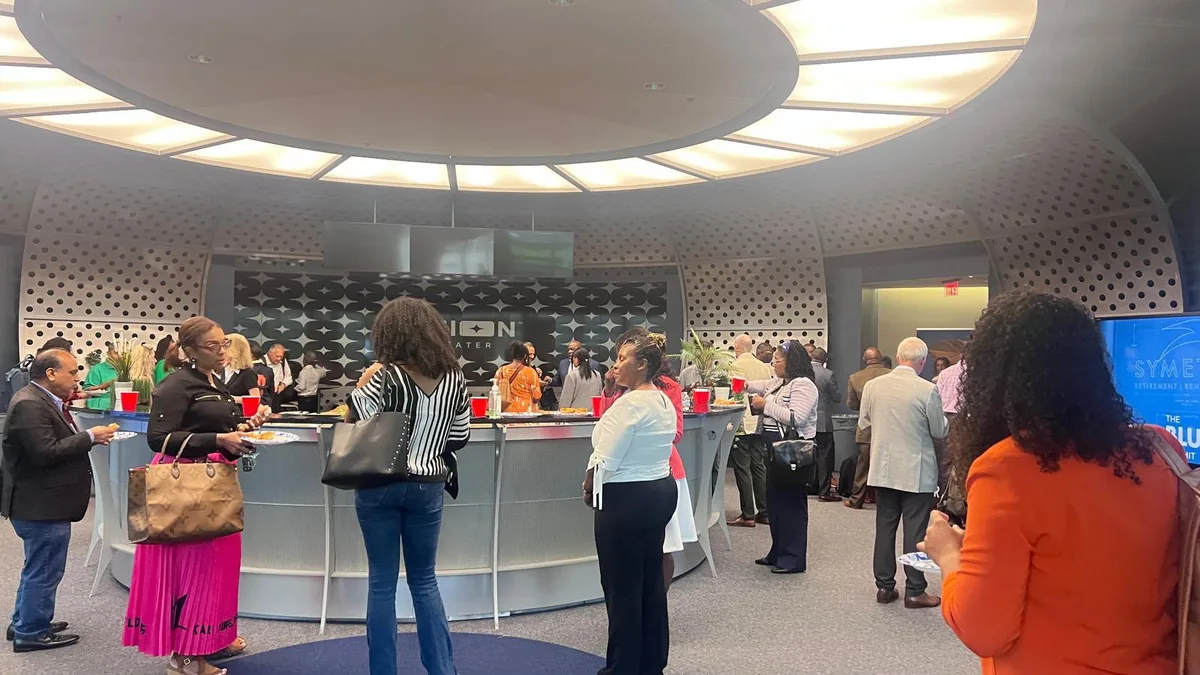 Guests mingling in the round lobby at the WealthWave Green Carpet event at World Park