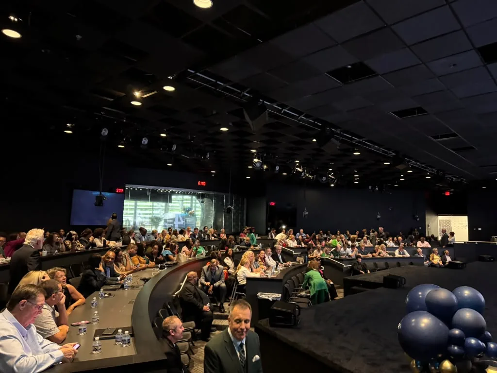 Theater filling with guests and balloons before the WealthWave grand opening at World Park