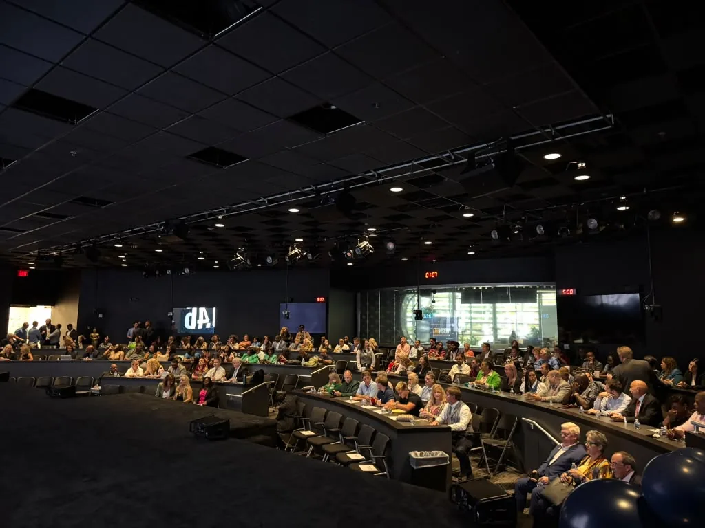 Guests seated in the theater during the WealthWave grand opening at World Park